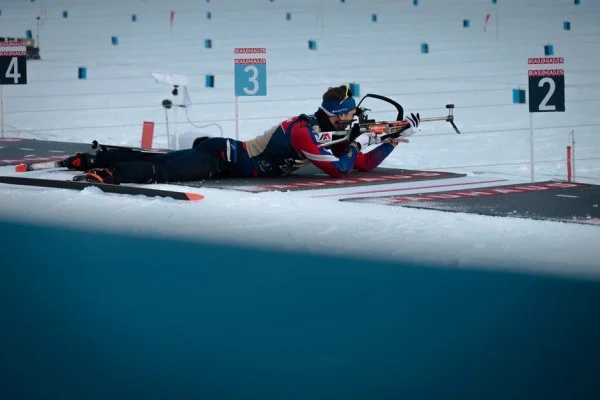 athlete aiming rifle target